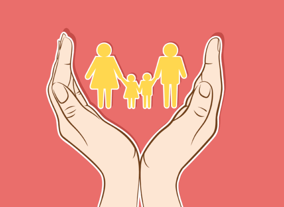 A pair of hands holding a paper cut-out of a four person family.